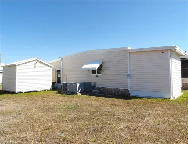 Back of house with a yard