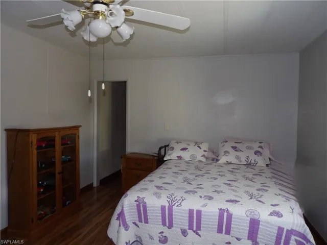 Spacious Bedroom with ceiling fan and laminated flooring.