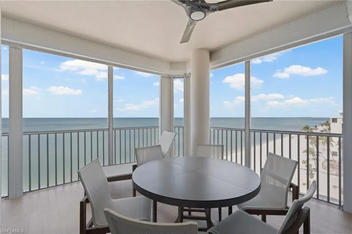 Sunroom featuring a wealth of natural light, a water view, and ceiling fan