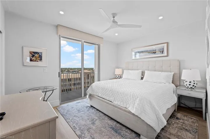 Bedroom with access to exterior, light hardwood / wood-style flooring, and ceiling fan
