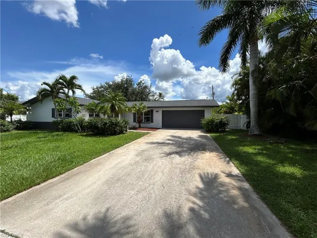 Single story home with a front lawn and a garage