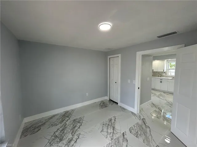 Unfurnished bedroom featuring light tile patterned floors and a closet