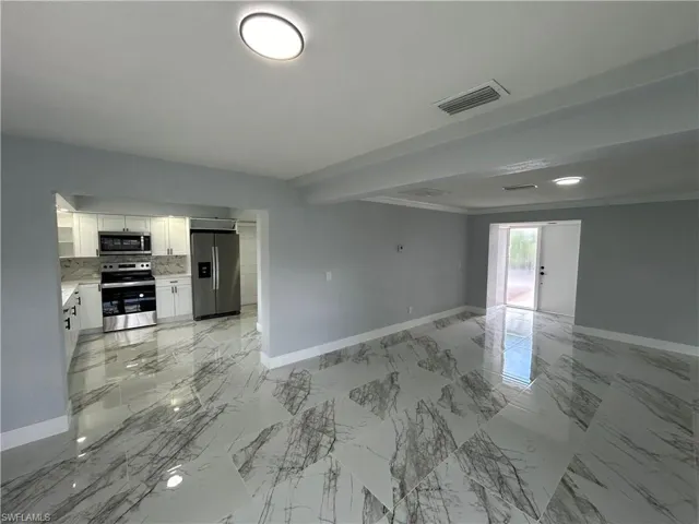 Unfurnished living room with light tile patterned floors