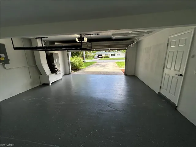Garage featuring a garage door opener