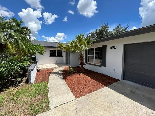 View of front facade featuring a garage