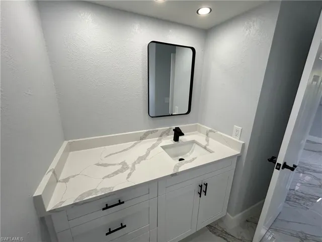 Bathroom featuring tile patterned flooring and vanity