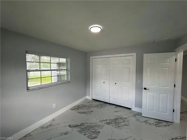Unfurnished bedroom with tile patterned floors and a closet