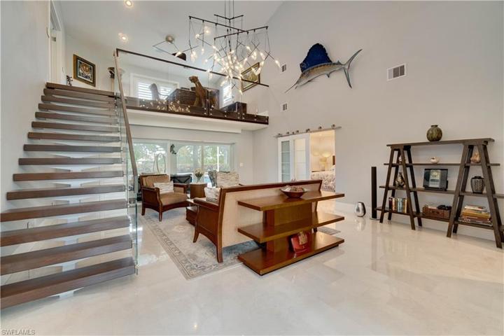 Featuring Mahogany and glass staircase.