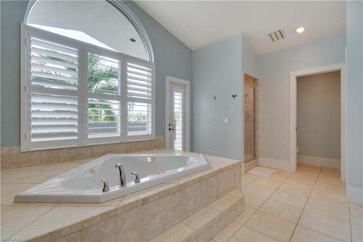 Jacuzzi tub, large walk in shower with dual shower heads and separate toilet room with sink.