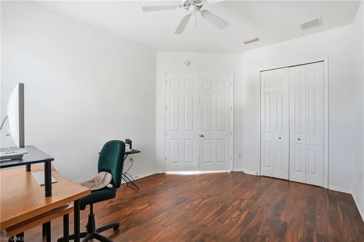 Home office featuring dark wood finished floors and ceiling fan