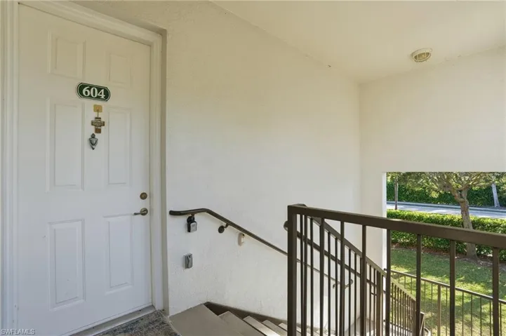 Doorway to property featuring stucco siding