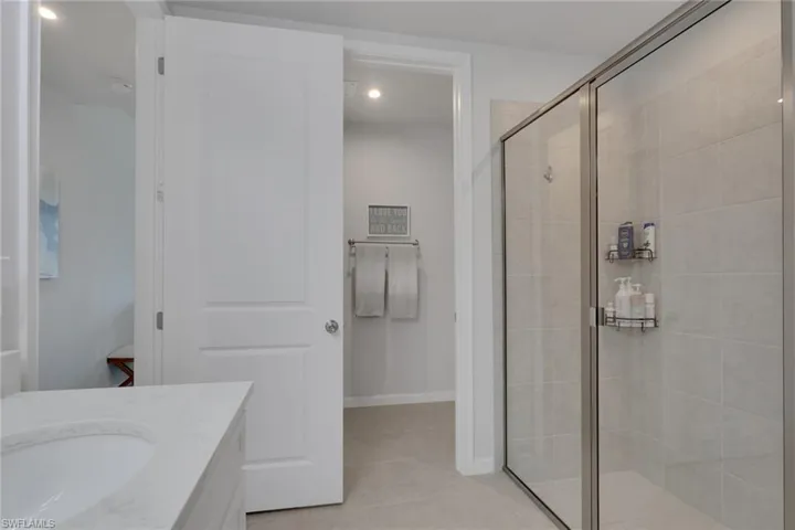 Bathroom featuring vanity, a stall shower, and recessed lighting