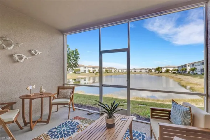 Sunroom / solarium featuring a water view