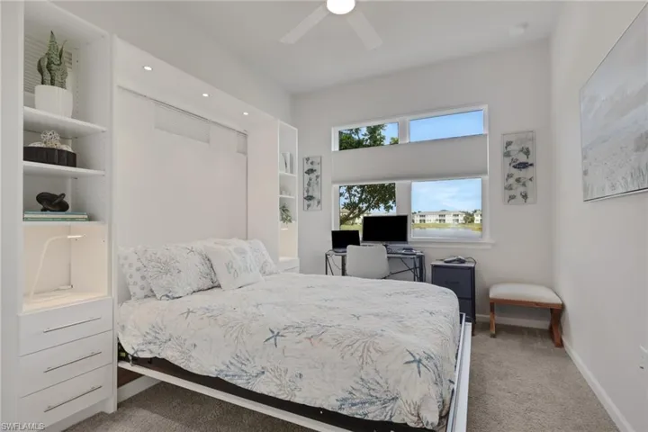 Bedroom with light colored carpet and ceiling fan