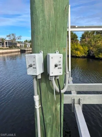 Dock area featuring a water view - boat lift with electric in place