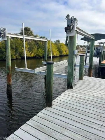 Dock featuring boat lift and a water view