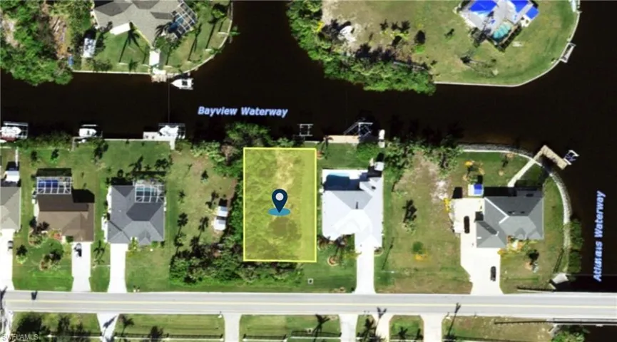 Aerial perspective of suburban area with property boundaries highlighted and a nearby body of water