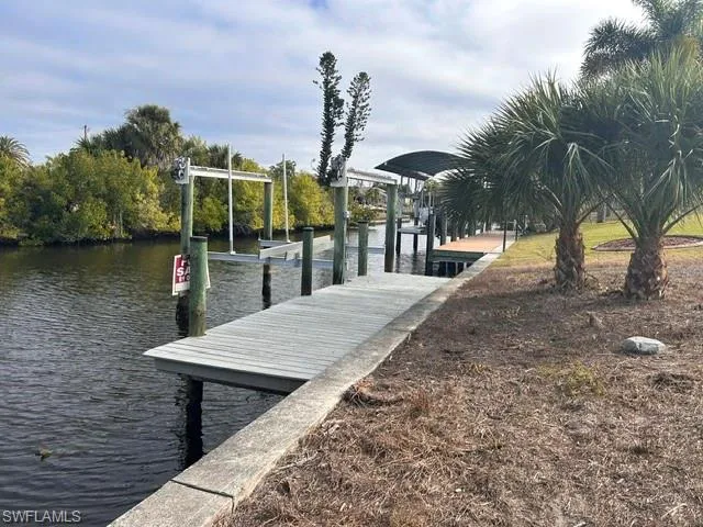 Dock area featuring a water view and boat lift