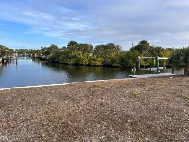 Dock area with boat lift and a water view