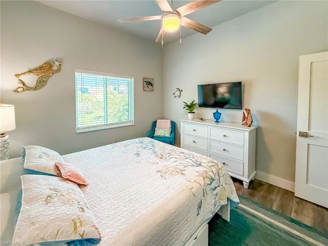 Bedroom featuring a ceiling fan and dark wood-type flooring
