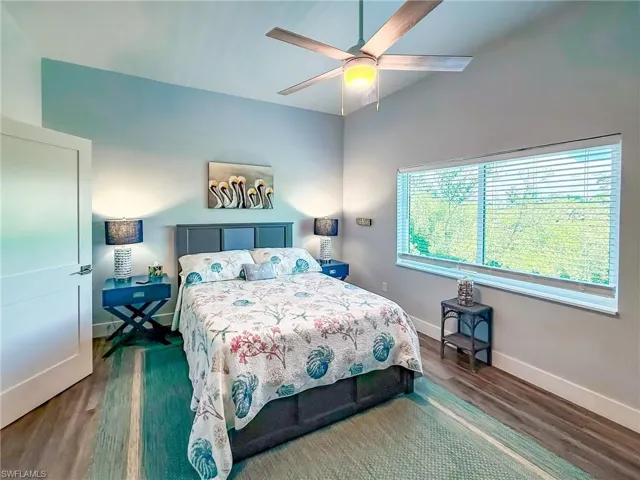 Bedroom with wood finished floors, a closet, and ceiling fan
