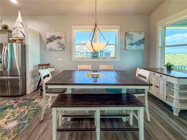 Living room featuring ceiling fan, lofted ceiling, light wood finished floors, and recessed lighting