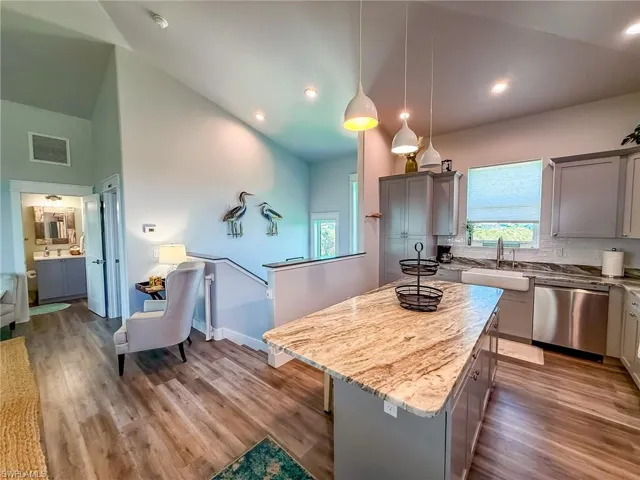 Bathroom with shower / bath combo, vanity, and dark wood-style floors