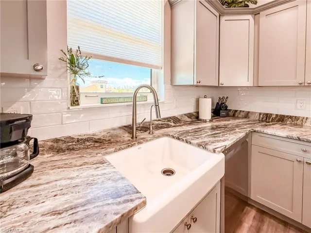 Kitchen featuring gray cabinets, a kitchen island, light wood finished floors, and recessed lighting