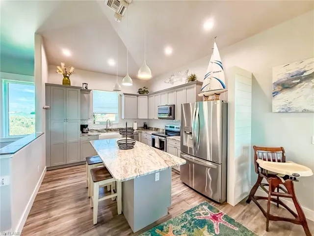 Living area featuring vaulted ceiling and wood finished floors