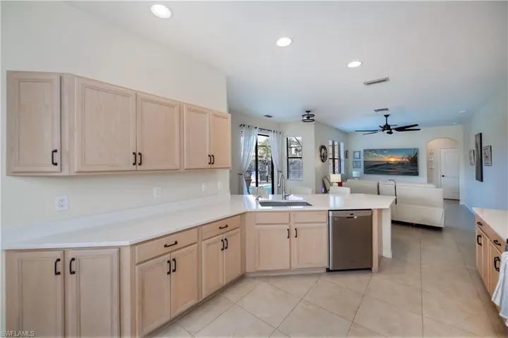 kitchen looking into family room and hallway to guest bedroom and guest bath/pool bath