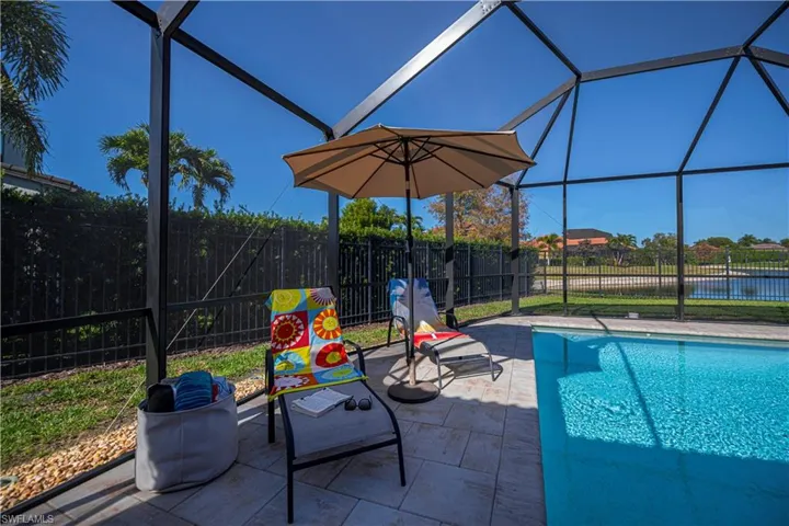 pool water view and 6 ft fence side of house