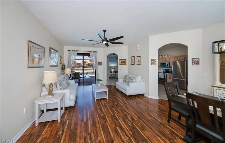 front entry looking into the living room dining room and out to lanai with pool and lake view