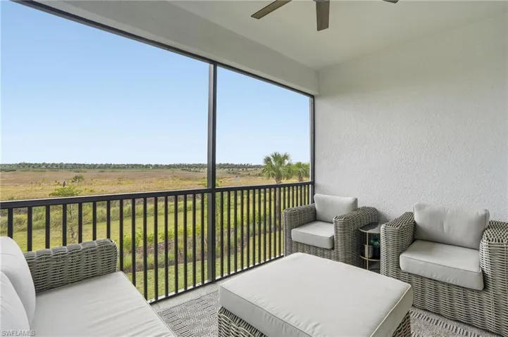 Sunroom / solarium featuring a ceiling fan, a balcony, a view of rural / pastoral area, and outdoor lounge area