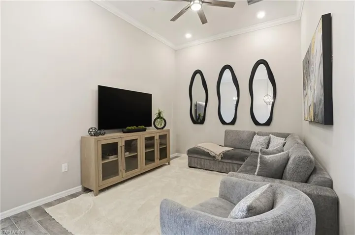 Living room with crown molding, ceiling fan, and recessed lighting