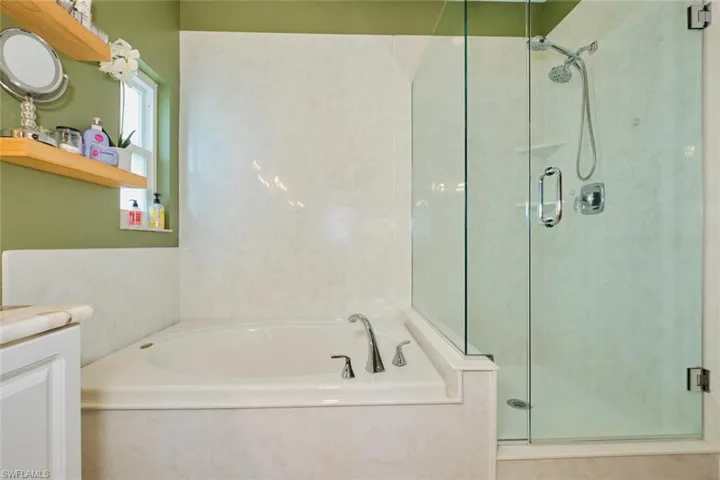 soaking tub and glassed in shower