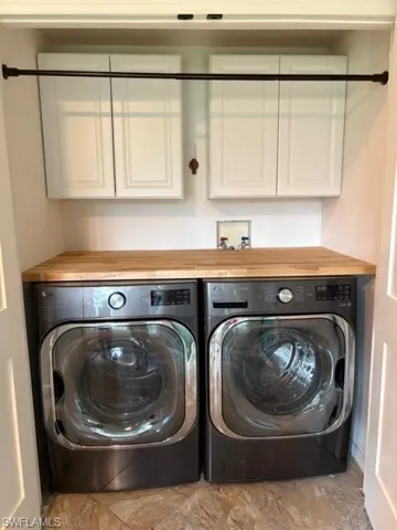 Laundry room featuring cabinet space and washing machine and dryer