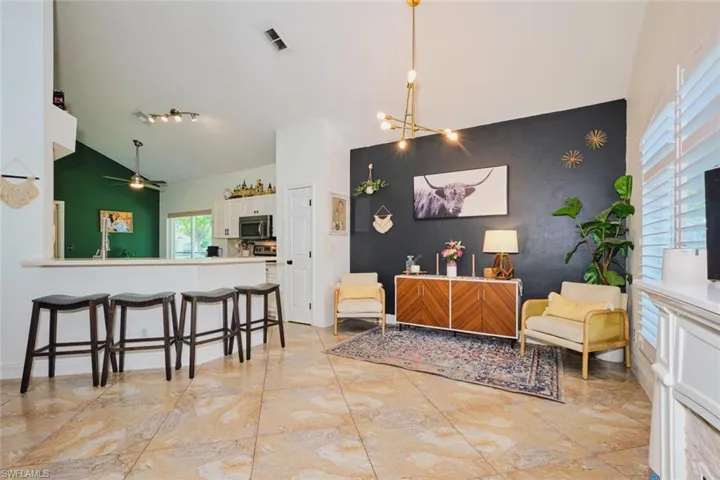 opens to kitchen and breakfast bar