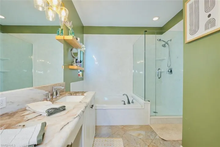 dual sinks, soaking tub and glassed in shower