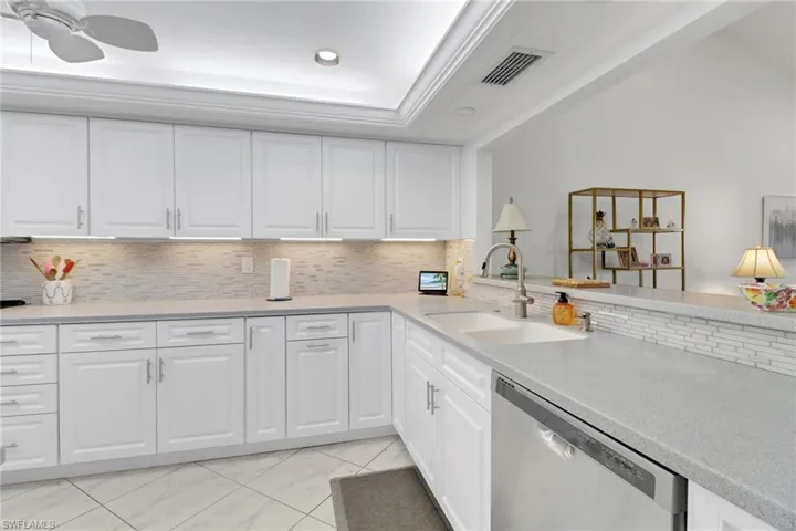 Kitchen featuring white cabinetry, sink, and dishwasher