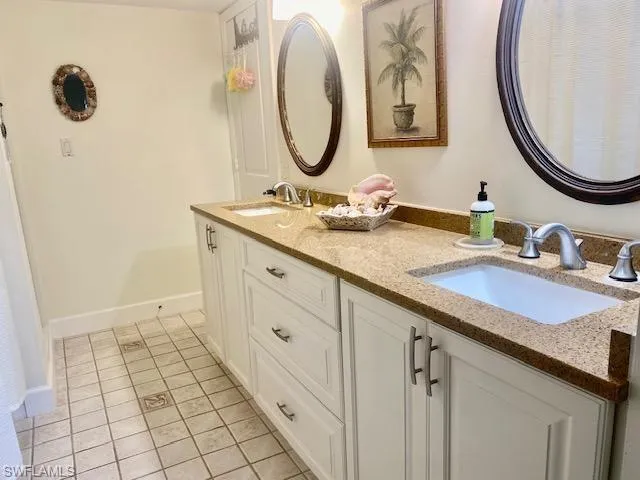 Bathroom with tile patterned flooring and vanity