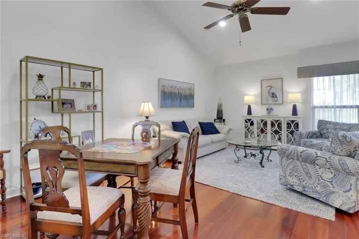 Dining space featuring ceiling fan, high vaulted ceiling, and hardwood / wood-style floors