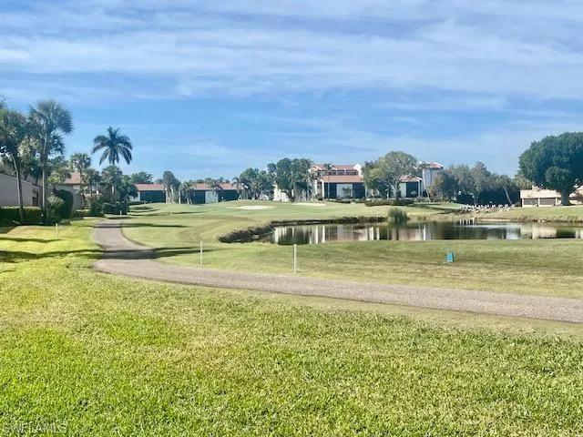 View of property's community featuring a water view and a yard