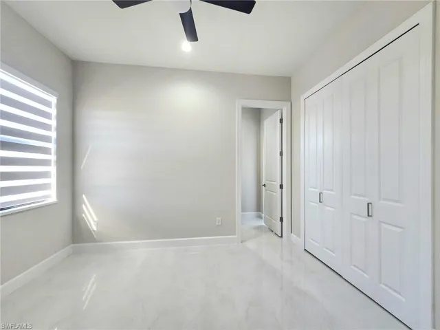 Unfurnished bedroom featuring ceiling fan and a closet