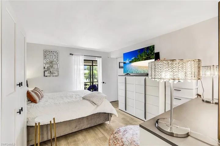 Bedroom featuring access to outside and light wood-style floors