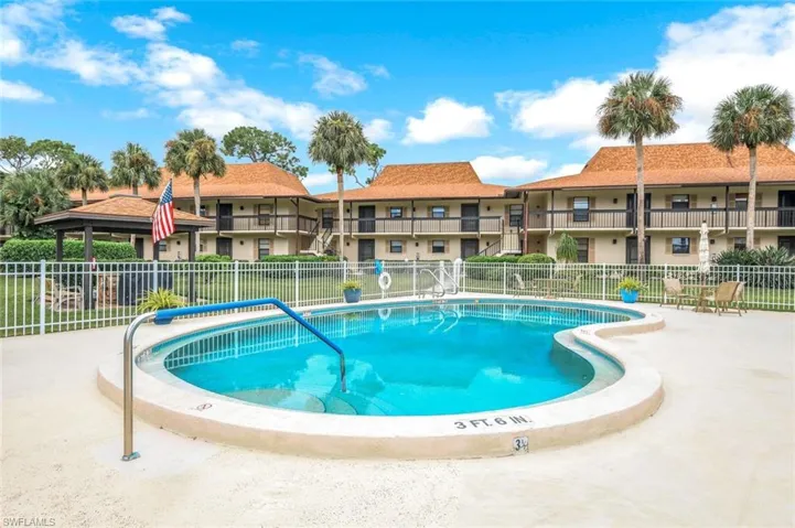 Community pool with a patio