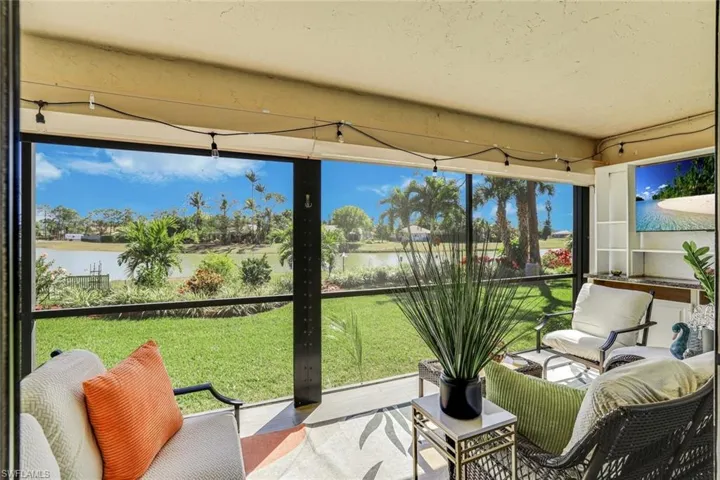Sunroom featuring a water view