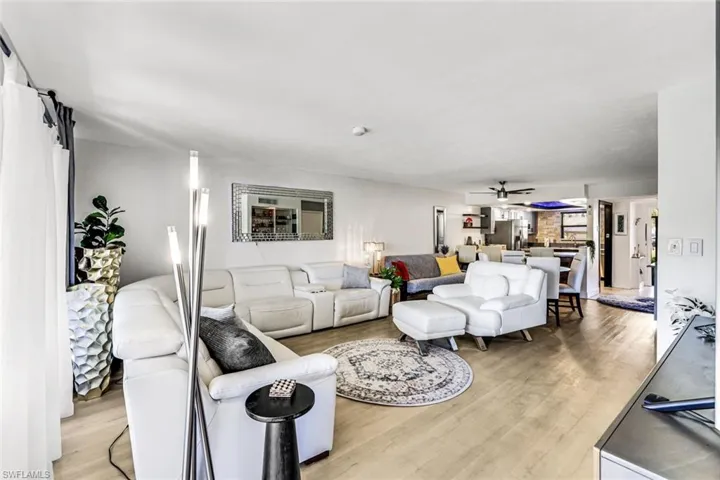 Living room featuring light wood-type flooring and a ceiling fan