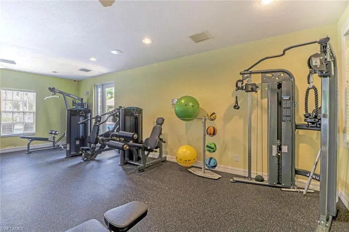 Gym featuring recessed lighting, ceiling fan, and a textured ceiling