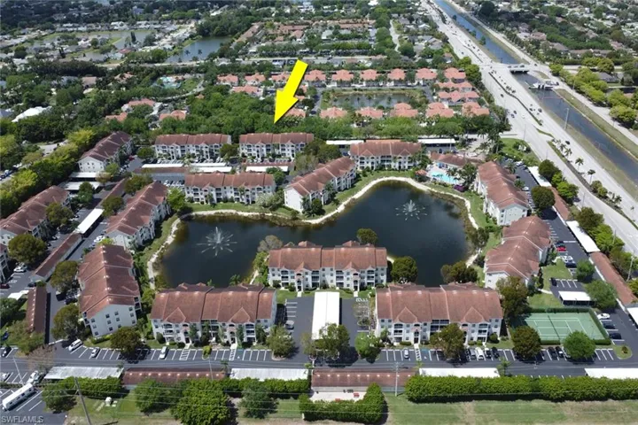 View of property location with a large body of water and apartment complex / building