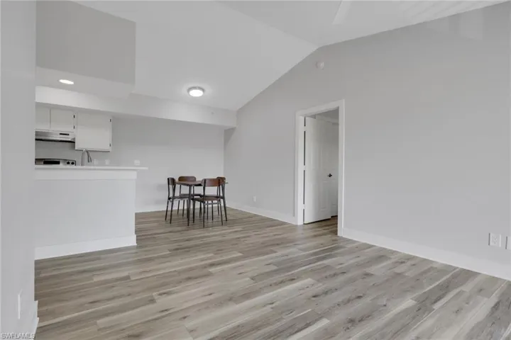 Living area featuring lofted ceiling and light wood-style floors
